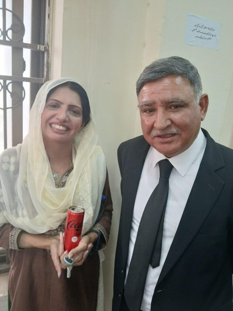 Tariq Aziz Bhatti with a supporter in Rawalpindi, PTI campaign event